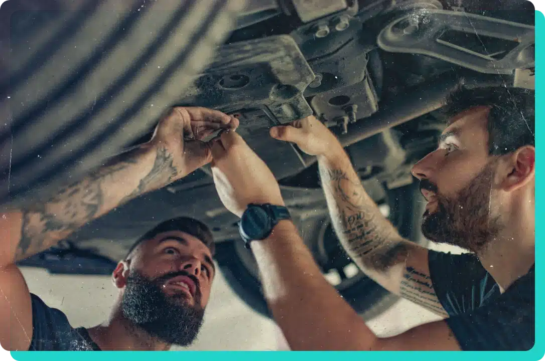 auto repair career in Wells, VT with Thomas' Auto Repair. Image of 2 male mechanics working underneath a car on lift in the shop to perform auto repairs.