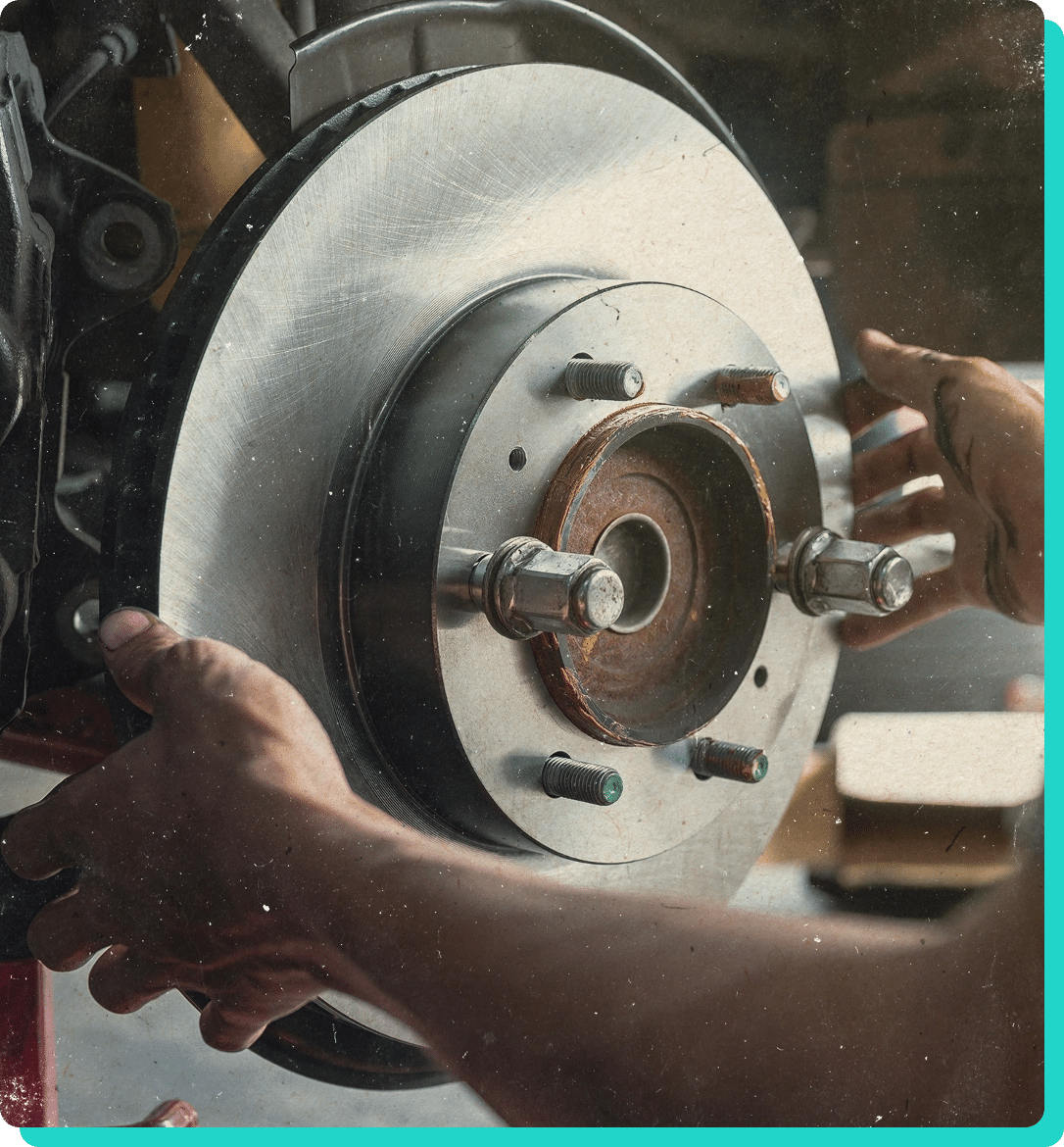 Brake repair in Wells, VT with Thomas' Auto Repair. image of mechanic hands installing new brakes on a truck in the shop.