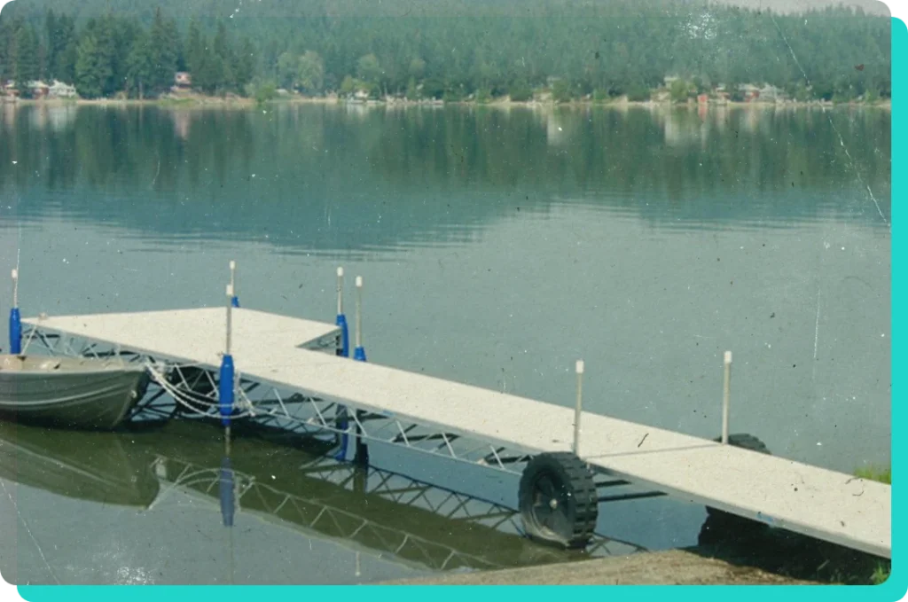 Boat launch dock on body of water with a small boat tied to it.