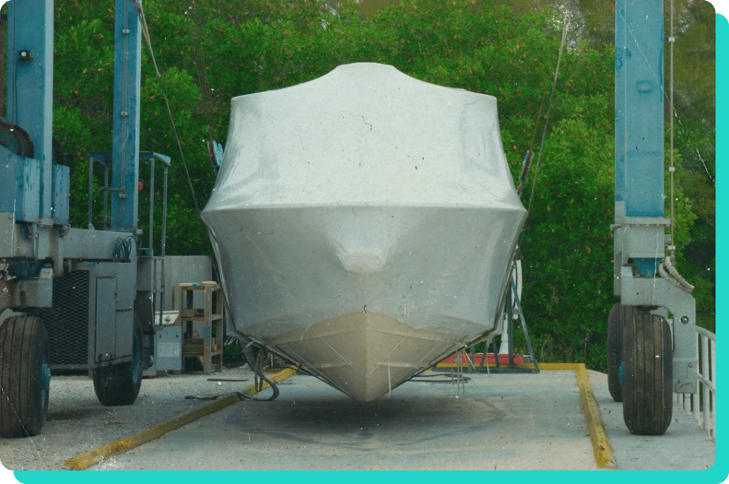 Image of recreational boat covered while parked at a marina