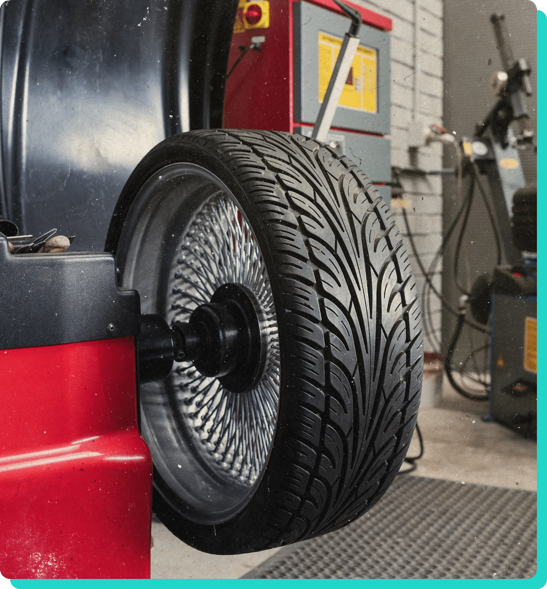 Tire repair, sales, installation and balancing in Wells, VT at Thomas' Auto Repair. Image of new tire being rotated on tire rotation machine in shop.